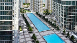 A modern urban complex with two rectangular swimming pools and high-rise buildings. - Icon Tower 3 (Miami)