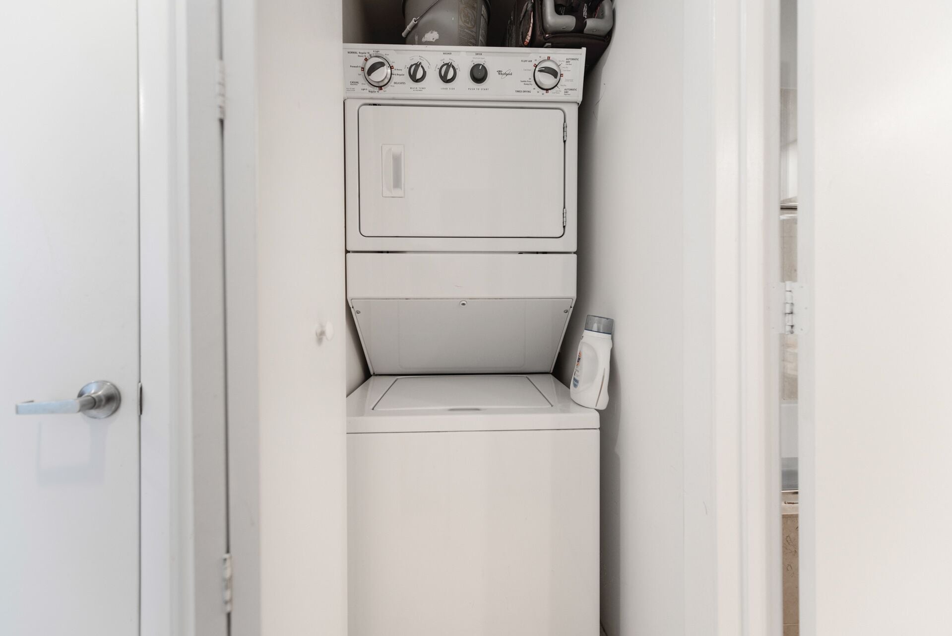 A compact, white, front-loading washer and dryer unit with a control panel featuring multiple settings.