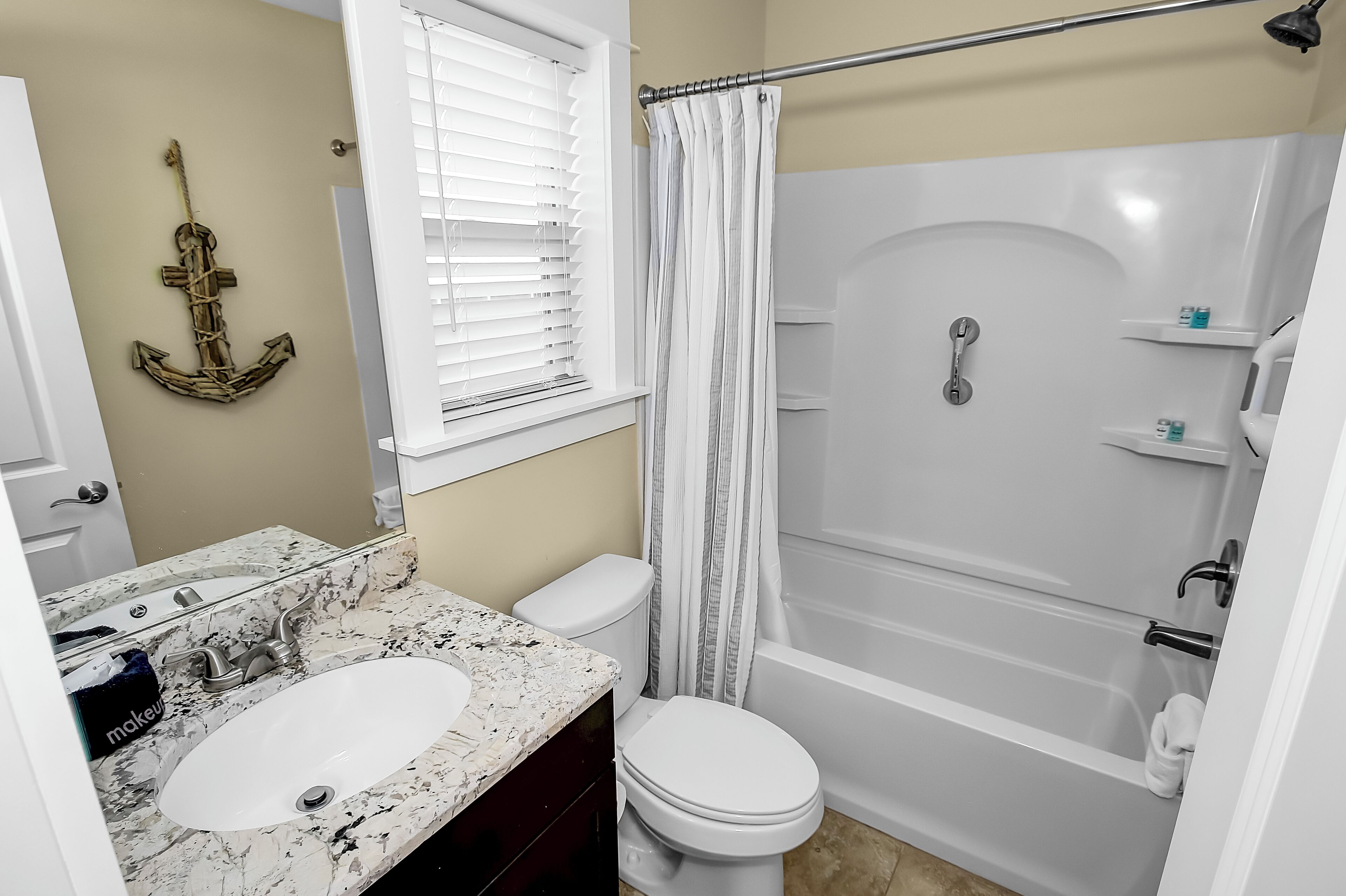 A bathroom with a white sink, toilet, and bathtub.
