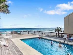 A pool area with a view of the ocean, lounge chairs, and a wooden deck. - Come Be At Peace! Spacious 3 Bd/3ba Beach Home! Sleeps 10! (Panama City Beach)