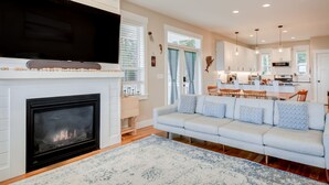A modern living room with a fireplace, a sofa, and a television.