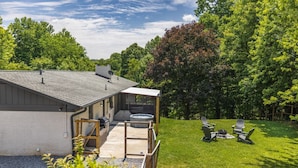 A modern house with a covered patio, a hot tub, and outdoor seating. - Mid-century Modern Remodel near Pisgah & Asheville (Asheville)