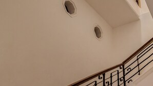 A staircase with a curved railing and multiple small windows. - Narrativ Lofts -Numen- Stylish Hideaway (Campeche)
