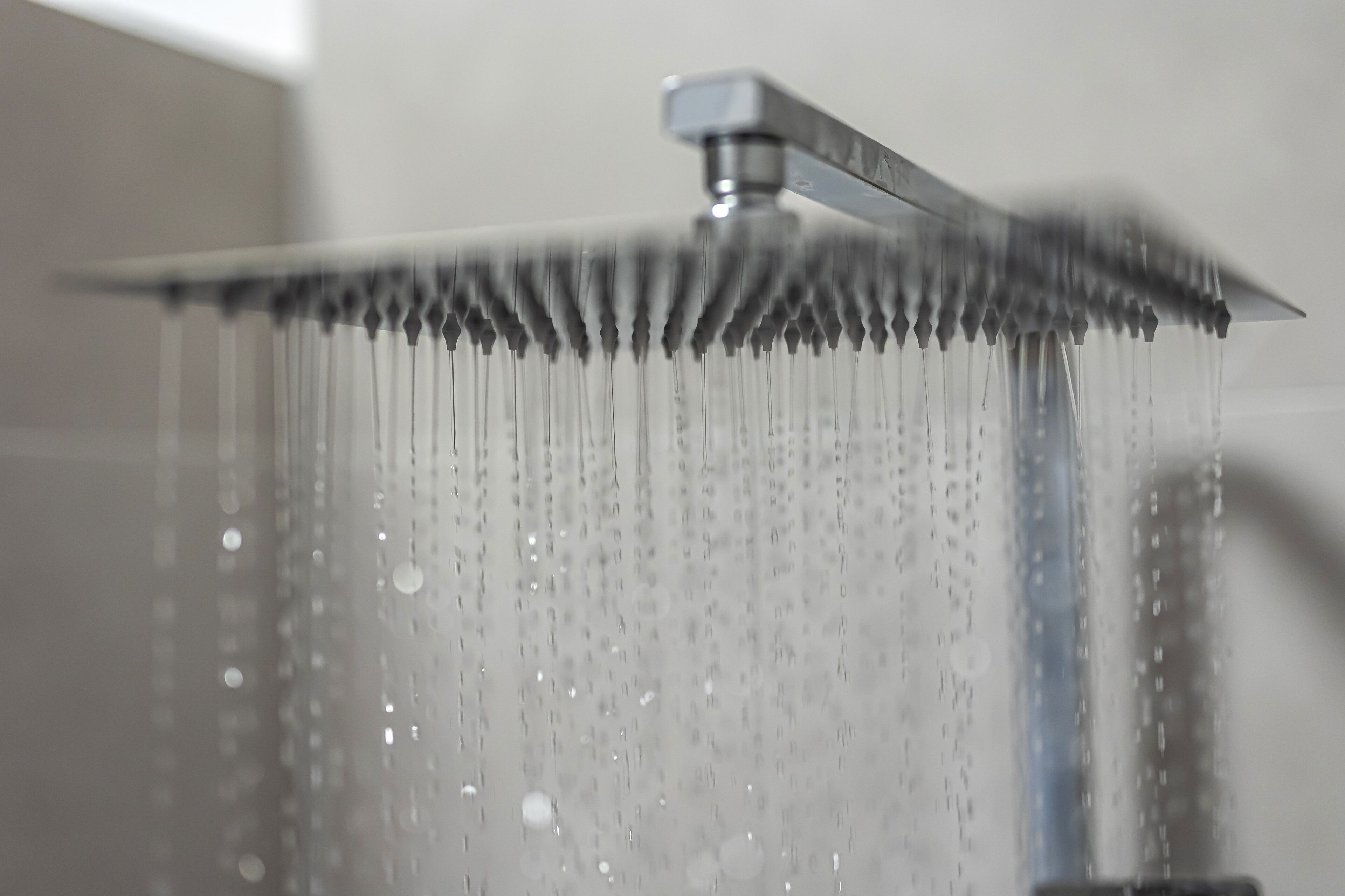 A showerhead with water flowing down.