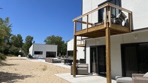A modern house with a wooden deck, a pool, and outdoor seating. - 90 min from Chicago, Pool, Hot Tub, Pet Friendly come enjoy After Dune Delight (Stevensville)