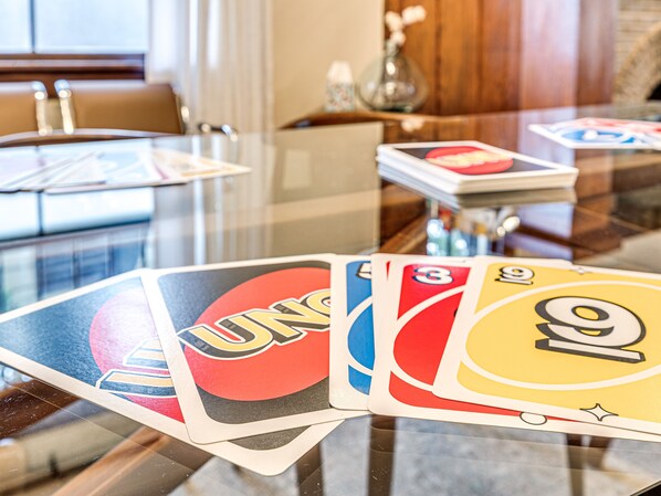 Una mesa de vidrio con una baraja de cartas UNO.