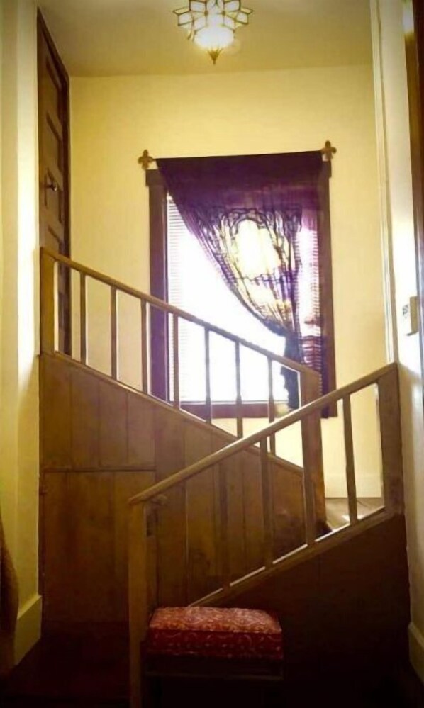 A wooden staircase with a handrail and a small bench at the bottom. - The Idyll: Stay in a re-purposed church (Winslow)