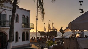 A coastal building with arched windows and a balcony, overlooking the sea. - HOTEL PUEBLITO VALLARTA (Puerto Vallarta)