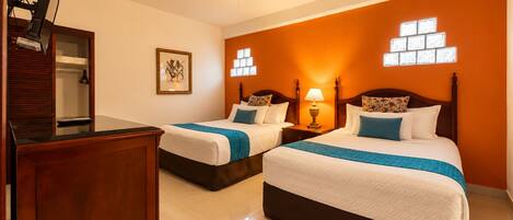 A hotel room with two beds, a wooden dresser, a ceiling fan, and a wall-mounted light fixture.