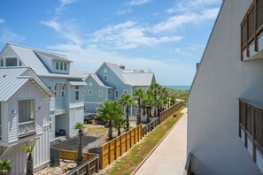 A coastal residential area with houses featuring gabled roofs and a wooden fence. - La Mirage Condo 200 Beachfront Condo Resort with Private Boardwalk to Beach (Port Aransas)
