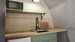 A compact kitchenette with a microwave, a sink, and a small countertop. - Red Owl Retreat-The Nook. (Bigfork)
