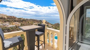 A balcony with a view of a coastal landscape, a table, and two chairs. - CostaBlancaDreams - Villa Paraguana in Benitachell (Benitachell)