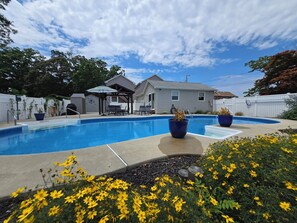 A backyard with a swimming pool, a covered patio, and a house. - The Perfect Escape with Gorgeous Heated In-Ground Pool (Lower Township)