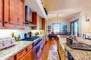 Enjoy meals in a well-appointed kitchen with ample counter space and a dining area.