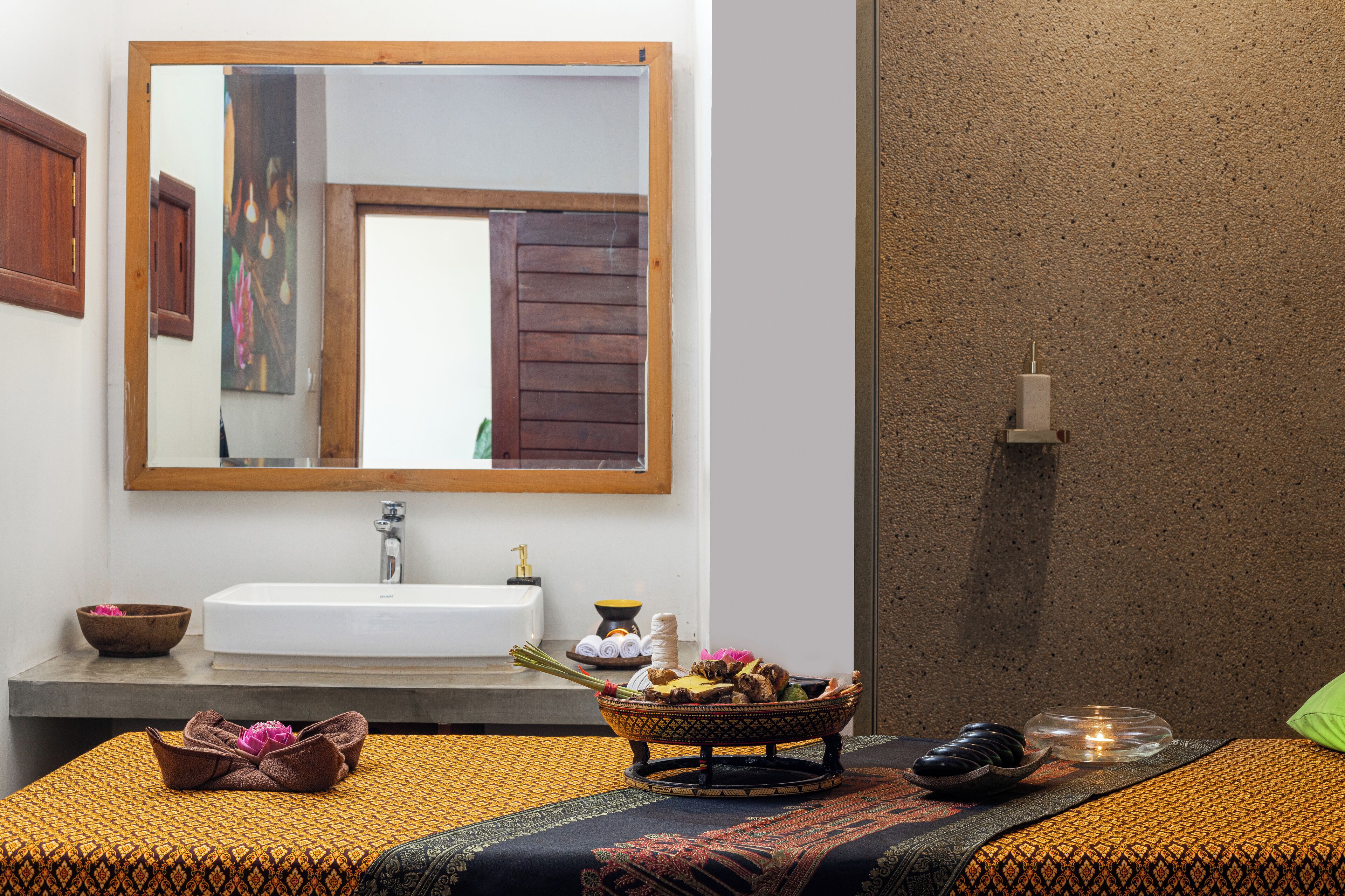 A bathroom with a large mirror, a sink, and a towel rack.