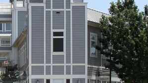 A multi-story building with a central tower and a covered balcony. - Modern Oasis in Plano, Texas! 2 Spacious Units, Full Kitchen, Pets Allowed! (Plano)