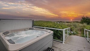 A hot tub on a wooden deck with a sunset view. - Outstanding Ocean Front Home, Pet Friendly, Hot Tub, Pool Table, Games, Seconds From Beach (Rockaway Beach)
