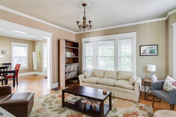 A living room with a sofa, coffee table, and bookshelf.