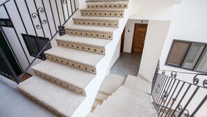 A staircase with patterned carpet and metal railings. - Beautiful Casa Madero 470 (Puerto Vallarta)