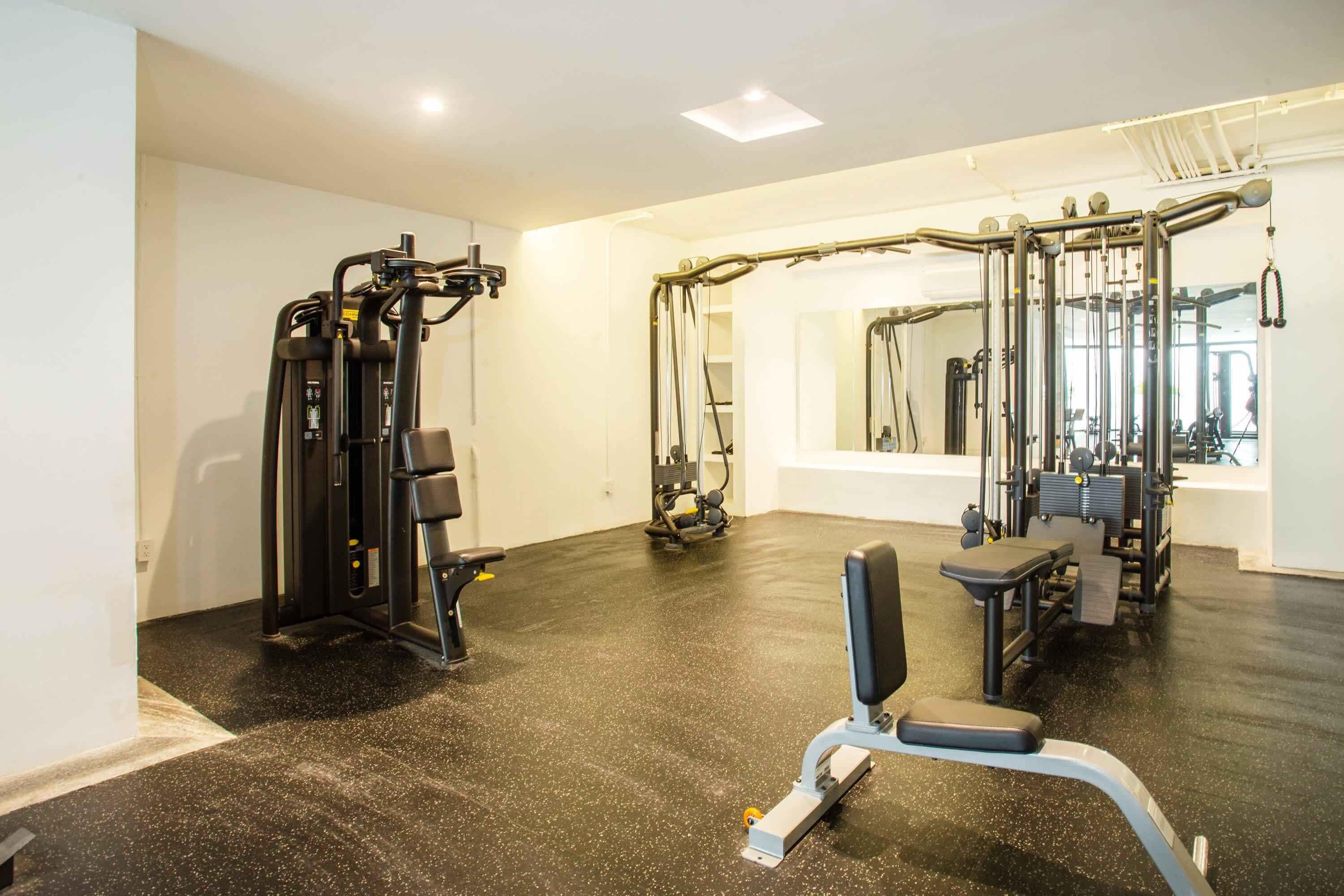 A gym with various exercise equipment, including weight machines and free weights.