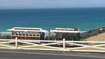 A coastal road with a bus stop and a view of the ocean.
