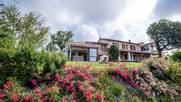 A large house with a spacious front yard and a well-maintained garden.