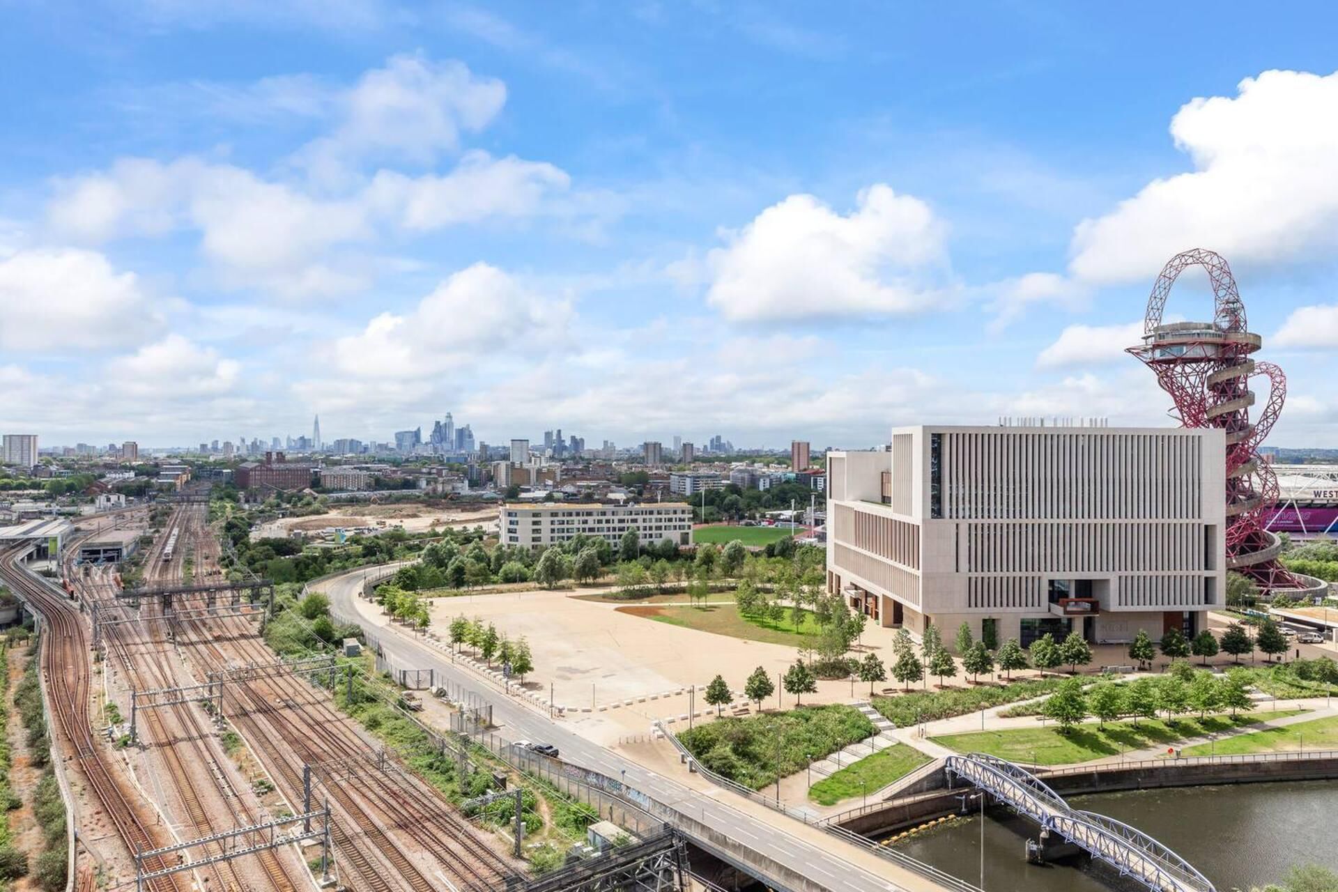 A modern building with a flat roof and a large open plaza.