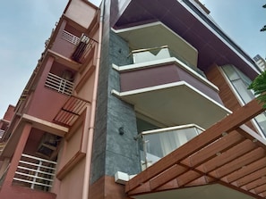 A multi-story residential building with balconies, a visible stairwell, and a modern architectural design. - Royal Sea View (Kanthi)