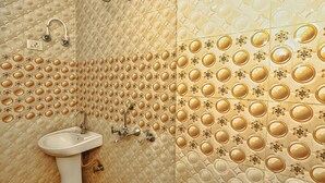 A bathroom with a sink and a shower. - Roomshala 084 Hotel Divine inn (Noida)