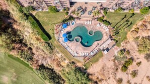 An aerial view of a resort with a large pool, sun loungers, and a covered patio area. - Best location in Lake Havasu! Walk to London Bridge!  Heated Pool & Golf. (Lake Havasu City)