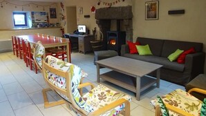 A living room with a fireplace, sofa, coffee table, and chairs.