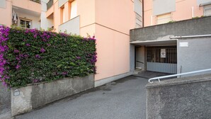 A narrow urban street with a concrete wall on one side and a building entrance on the other. - Apartment 'Casa Cogoleto Terrace and Parking' with Sea View, Wi-Fi and Air Conditioning (Cogoleto)
