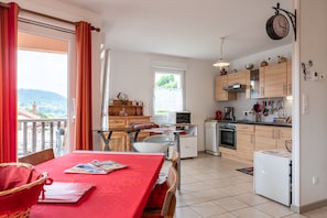 A kitchen with wooden cabinets, a microwave, and a refrigerator.
