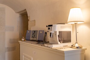 A coffee machine, a lamp, and a decorative item on a counter.