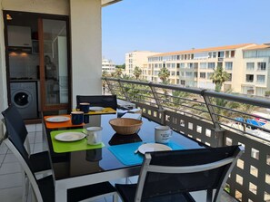 Enjoy meals on the balcony with a view of the surrounding residential area.