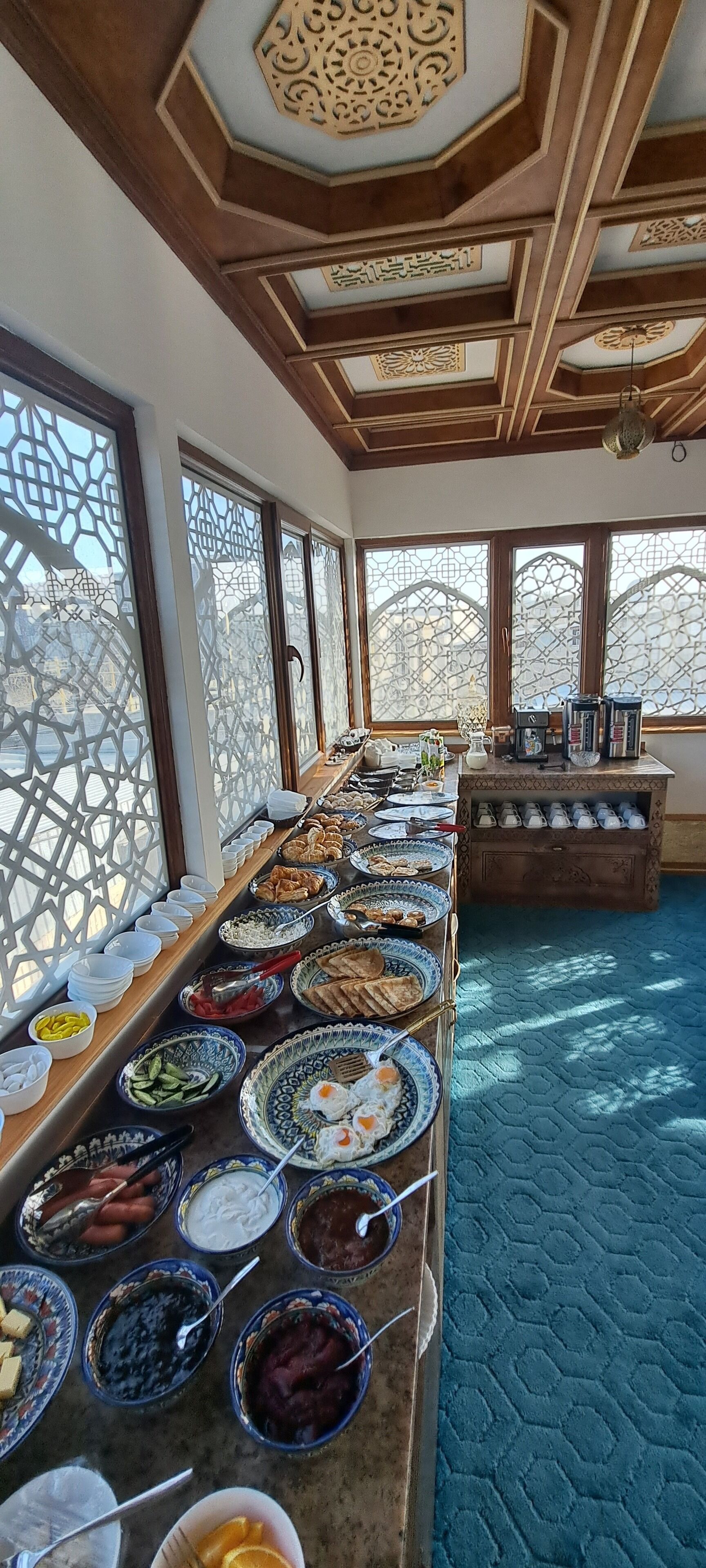 A buffet setup with various food items and utensils.