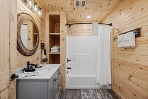 Combined shower/tub, towels, toilet paper - 6BR Cabin | Theater, Hot Tub, Game Room (Sevierville)