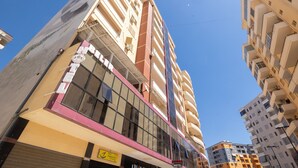 A multi-story hotel with a modern facade, large windows, and balconies. - Hotel Beler (Vlorë)