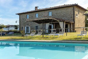 A stone building with a pool, outdoor seating, and a pergola. - Wonderful private villa with private pool, internet, A/C, patio, pets allowed and panoramic view (Badia Agnano)