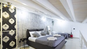 A modern bedroom with a large bed, bedside tables, and a decorative wall.