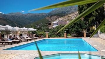 Seasonal outdoor pool, open 7:30 AM to 10:30 PM, pool umbrellas