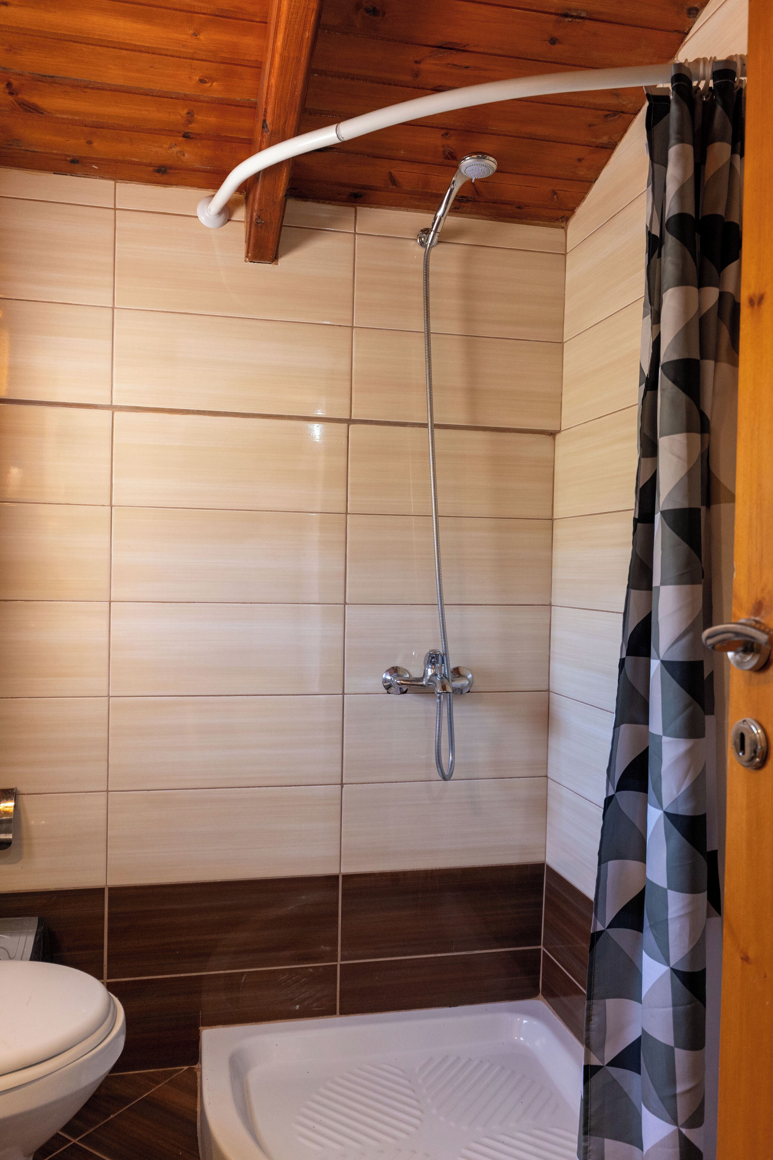 A bathroom with a shower, toilet, and bathtub.