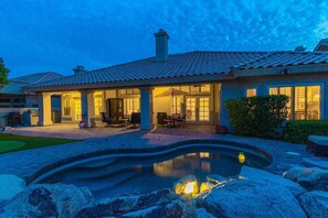 A house with a swimming pool, outdoor seating, and a well-lit patio area. - Ahwatukee Foothills with Pool & Golf Course Views (Phoenix)