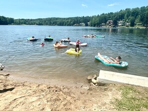 A lake with people floating on inflatable rafts. - Lake Demmon Lodge-Beach,Boats,Fishing,FUN!! (Bath)