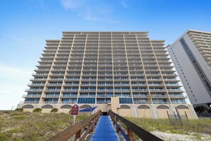 A multi-story hotel with a prominent entrance ramp leading to the main building.