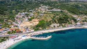 An aerial view of a coastal town with a beach, a marina, and buildings on a hillside. - Stylish property with heated 32sqm private pool, 5 bedrooms, 5 bathrooms, 1km from the beach (Podstrana)