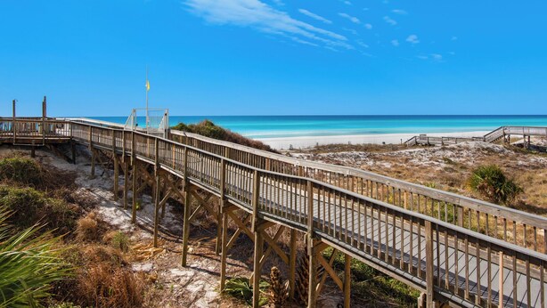 A wooden boardwalk leading to a beach with clear skies. - Great Second Cottage at Hidden Dunes (Miramar Beach)