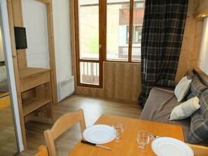 Enjoy meals at the dining table, relax on the sofa, and take in the view from the large window.