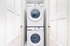 A compact laundry room with two stacked washing machines. - Aruba Escape! 2BR Condo w Shared Pool Near Beaches (Noord)