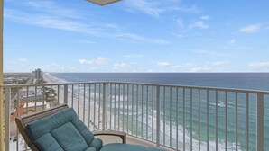 A balcony with a view of the ocean and a beach. - Emerald Isle 2110 - Front row beach chair service included! Affordable rates (Panama City Beach)
